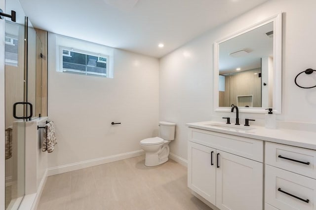 bathroom with vanity, toilet, baseboards, recessed lighting, and a stall shower