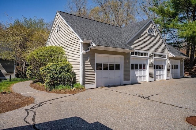 7 Brewster Ln Unit 7, Acton, MA 01720 - view of home's exterior featuring aphalt driveway, a shingled roof, and a garage