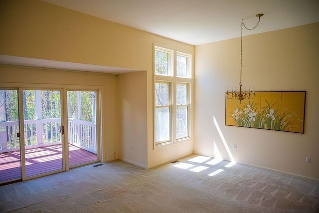 7 Brewster Ln Unit 7, Acton, MA 01720 - empty room with baseboards, carpet, a chandelier, and a wealth of natural light