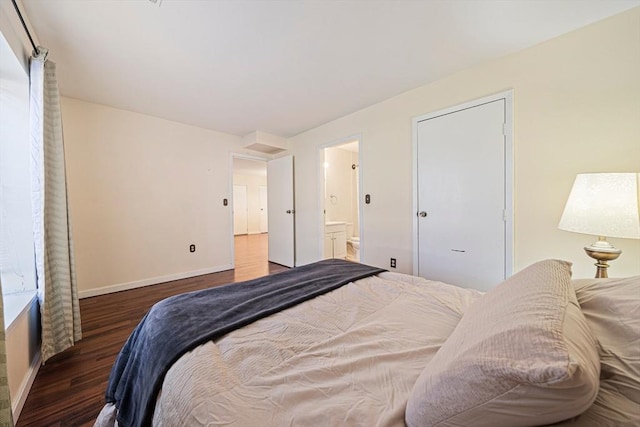 bedroom featuring baseboards, connected bathroom, and wood finished floors