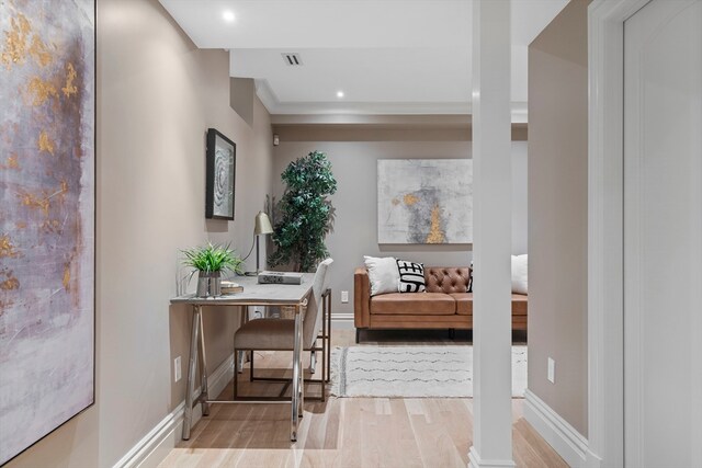 home office with light hardwood / wood-style flooring