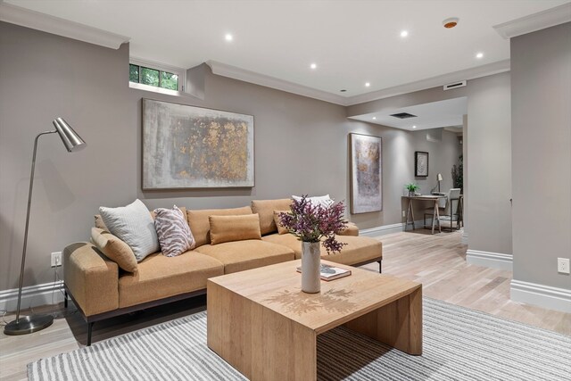 living room with light hardwood / wood-style floors and ornamental molding