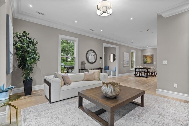 living area with visible vents, recessed lighting, light wood-style floors, and ornamental molding