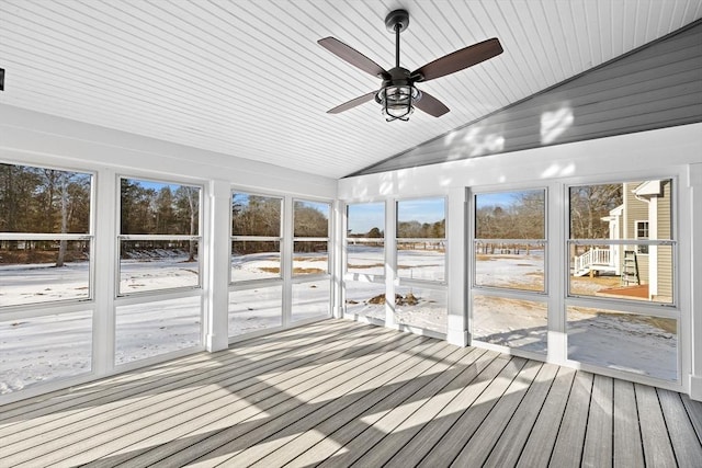 unfurnished sunroom featuring lofted ceiling and a healthy amount of sunlight