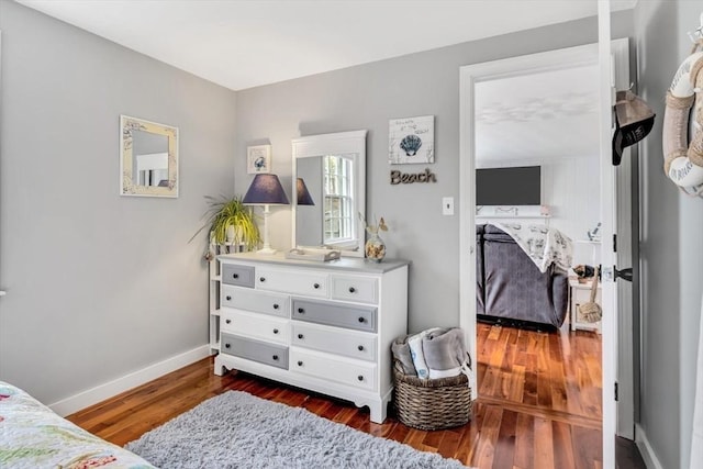 bedroom featuring dark wood-type flooring and baseboards