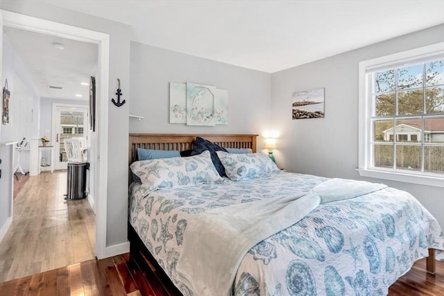 bedroom featuring wood finished floors and baseboards