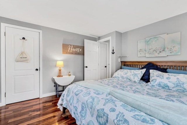 bedroom with wood finished floors and baseboards