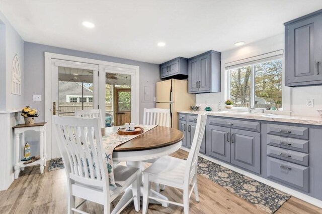 dining room with light wood finished floors and recessed lighting