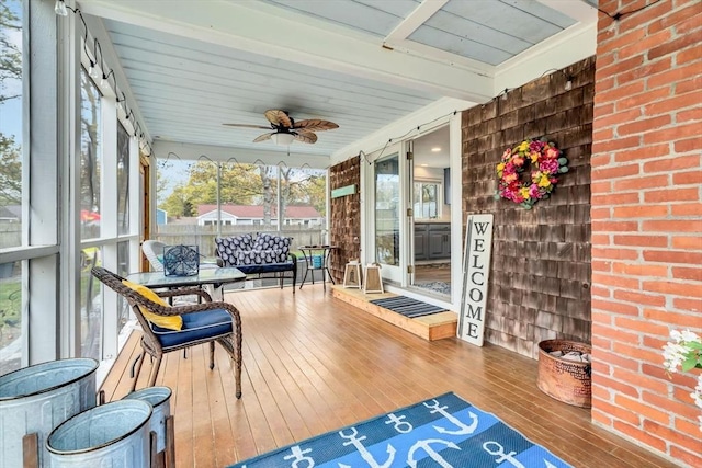 sunroom / solarium with a ceiling fan