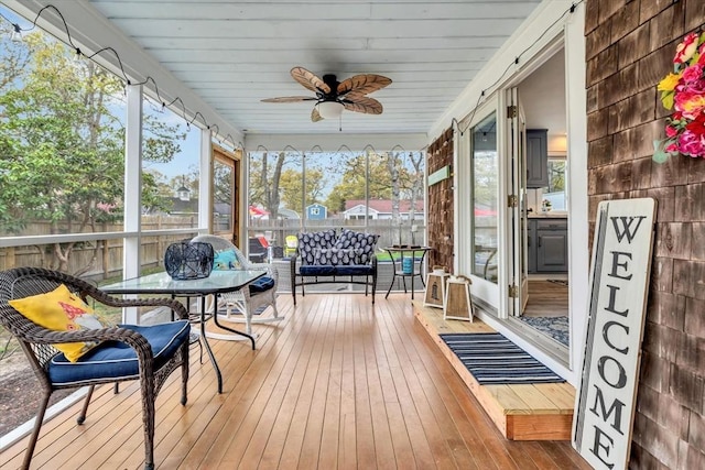sunroom with ceiling fan, plenty of natural light, and an outdoor living space