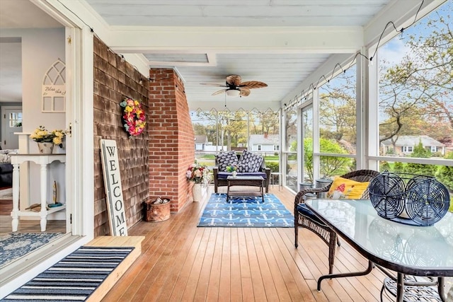 sunroom featuring a ceiling fan