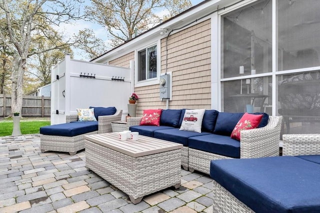 view of patio featuring fence and an outdoor hangout area