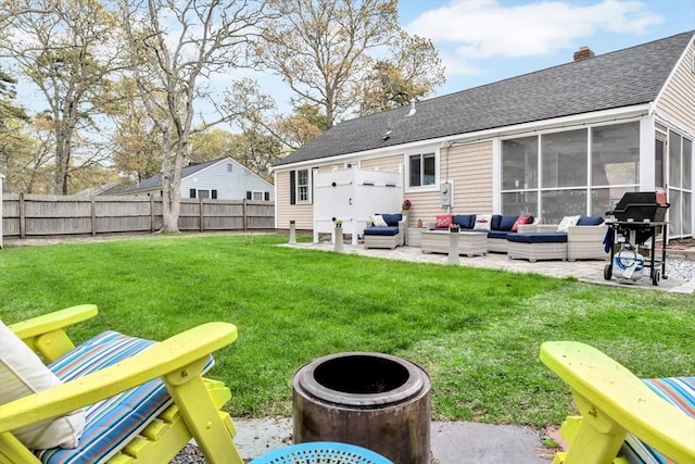 rear view of property featuring a patio, an outdoor hangout area, roof with shingles, a sunroom, and a chimney