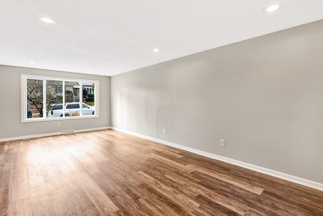 empty room with hardwood / wood-style floors