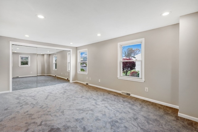 unfurnished room with dark carpet