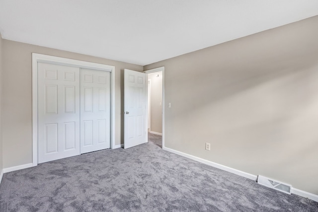 unfurnished bedroom featuring carpet floors and a closet