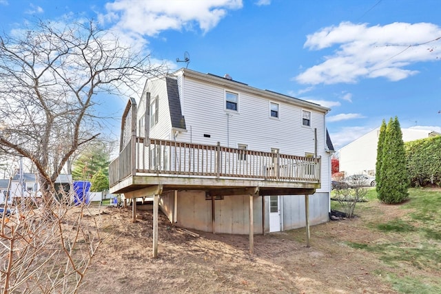 back of house featuring a wooden deck