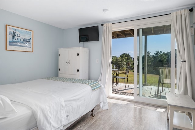 bedroom featuring access to outside and wood-type flooring