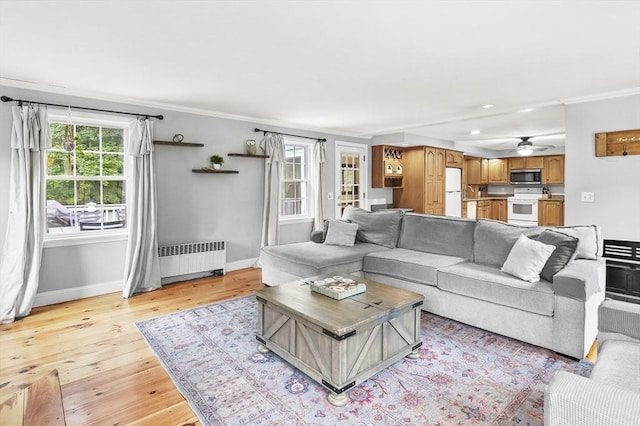 2 Putnam Ln, Auburn, MA 01501 - living area with radiator heating unit, plenty of natural light, light wood finished floors, ornamental molding, and recessed lighting