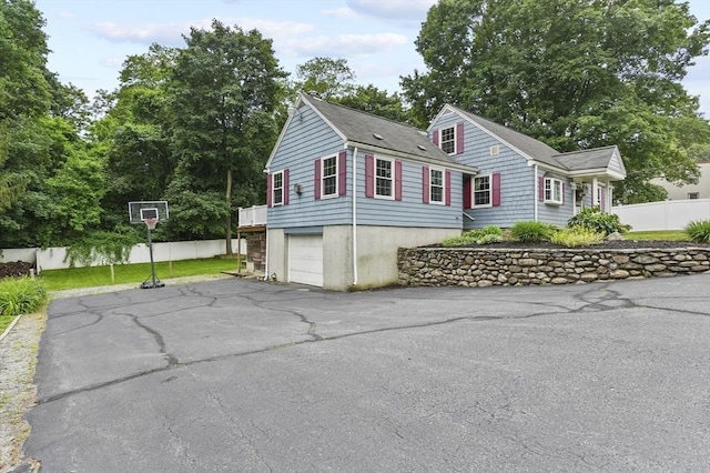 2 Putnam Ln, Auburn, MA 01501 - view of side of home with asphalt driveway, an attached garage, and a shingled roof