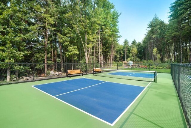 11 Juniper Ln Unit 14, Tyngsborough, MA 01879 - view of tennis court featuring a wooded view