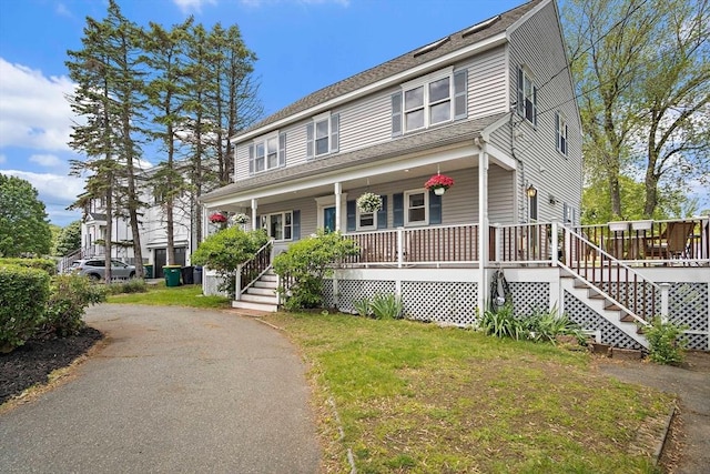 3 Manomet Rd, Woburn, MA 01801 - view of front facade with a porch, stairway, a front yard, and driveway