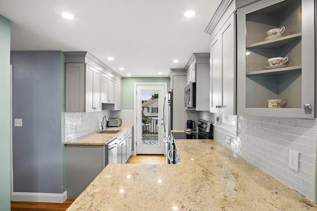 3 Manomet Rd, Woburn, MA 01801 - kitchen with appliances with stainless steel finishes, backsplash, light stone counters, a sink, and recessed lighting