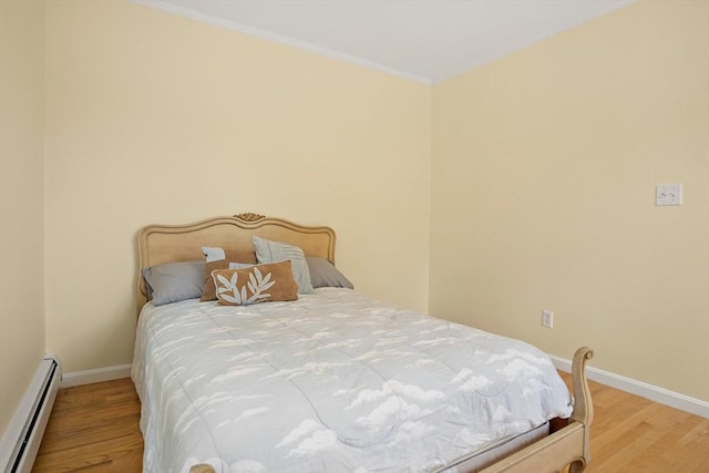 3 Manomet Rd, Woburn, MA 01801 - bedroom with a baseboard heating unit, wood finished floors, and baseboards
