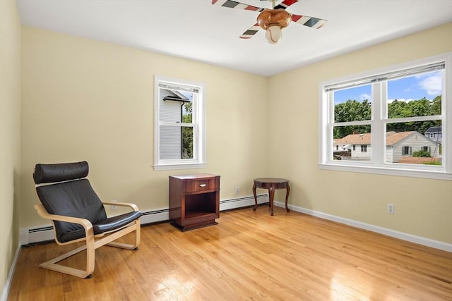 3 Manomet Rd, Woburn, MA 01801 - living area with light wood-style flooring, baseboard heating, a ceiling fan, and baseboards