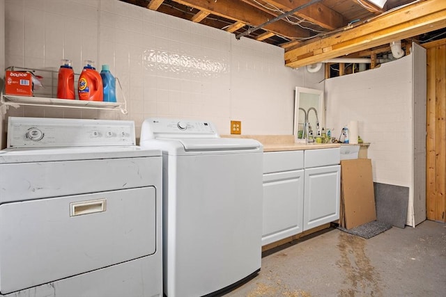 3 Manomet Rd, Woburn, MA 01801 - laundry area featuring washing machine and clothes dryer, cabinet space, and concrete block wall