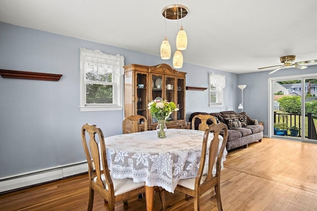 3 Manomet Rd, Woburn, MA 01801 - dining area featuring light wood-style flooring, a baseboard heating unit, and ceiling fan