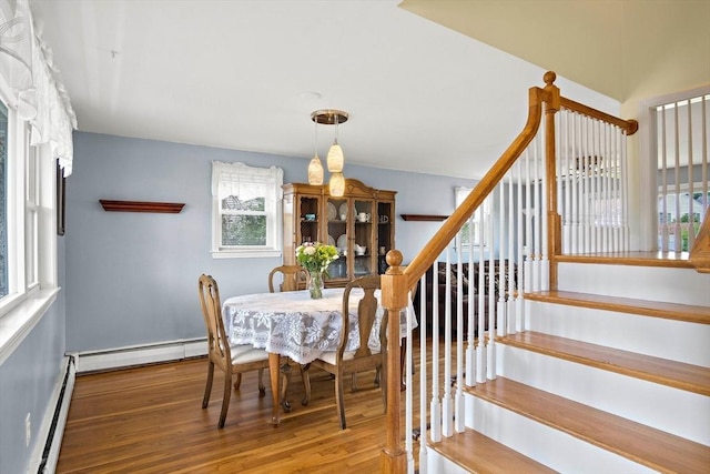 3 Manomet Rd, Woburn, MA 01801 - dining space featuring baseboard heating, a baseboard heating unit, plenty of natural light, and wood finished floors