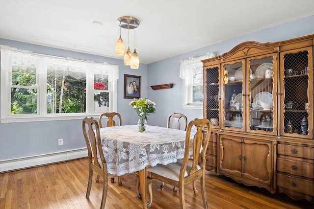 3 Manomet Rd, Woburn, MA 01801 - dining room featuring healthy amount of natural light, a baseboard radiator, wood finished floors, and baseboards