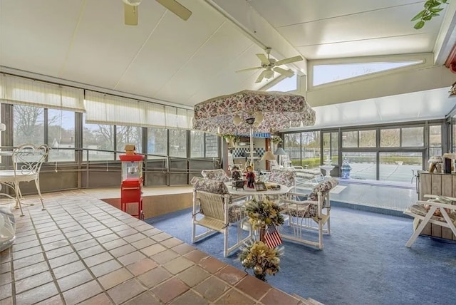 sunroom with ceiling fan, a healthy amount of sunlight, and lofted ceiling