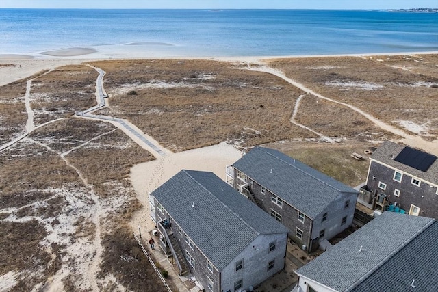 bird's eye view featuring a water view and a beach view