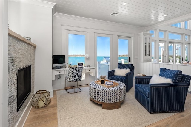 sunroom / solarium with visible vents, wooden ceiling, and a glass covered fireplace