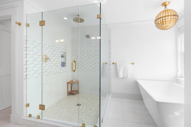 full bathroom with a shower stall, a freestanding tub, tile patterned floors, and ornamental molding