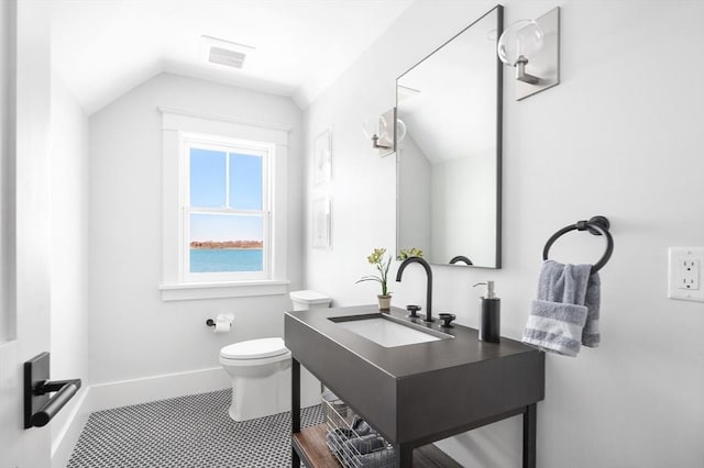 bathroom featuring visible vents, lofted ceiling, toilet, and baseboards