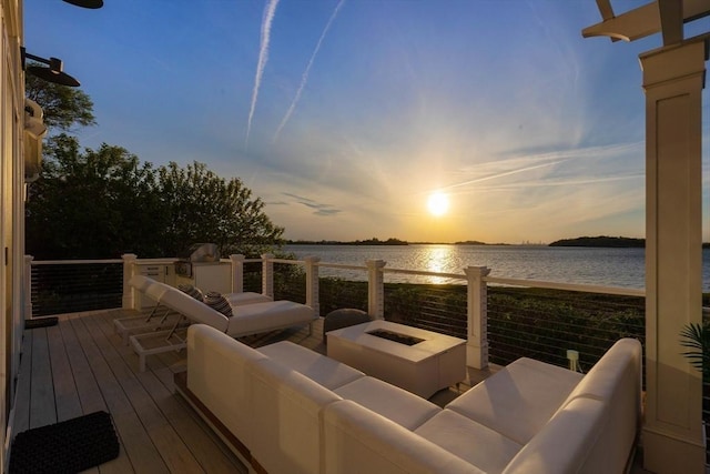 wooden terrace featuring an outdoor living space with a fire pit and a water view