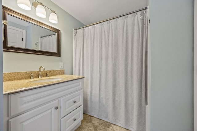 bathroom with curtained shower and vanity