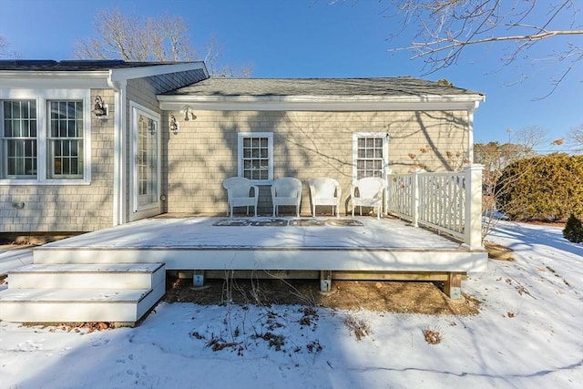 snow covered rear of property featuring a wooden deck