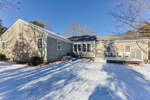 snow covered property featuring a wooden deck