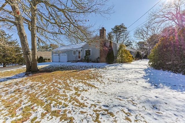 view of front facade featuring a garage and a chimney