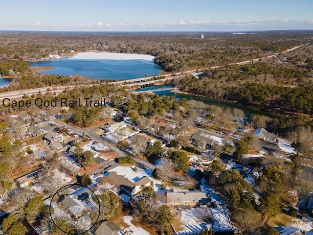 drone / aerial view with a residential view, a wooded view, and a water view