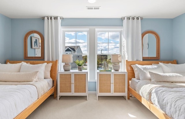 bedroom featuring light colored carpet