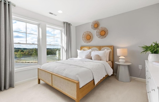 carpeted bedroom featuring multiple windows