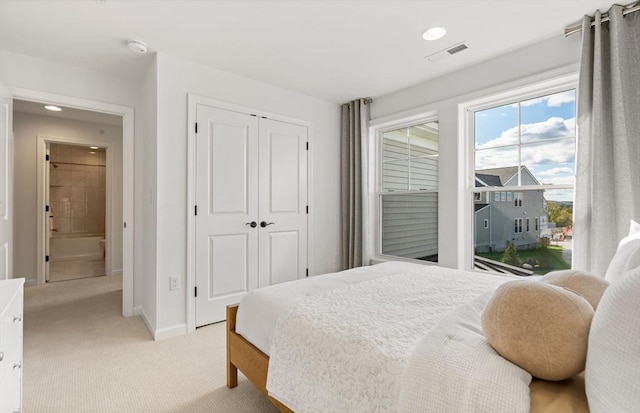 carpeted bedroom with a closet