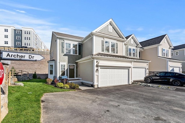 view of front of property with a front yard and a garage