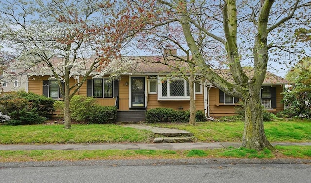 70 Bestick Rd, Braintree, MA 02184 - view of front of house with a front lawn and a chimney