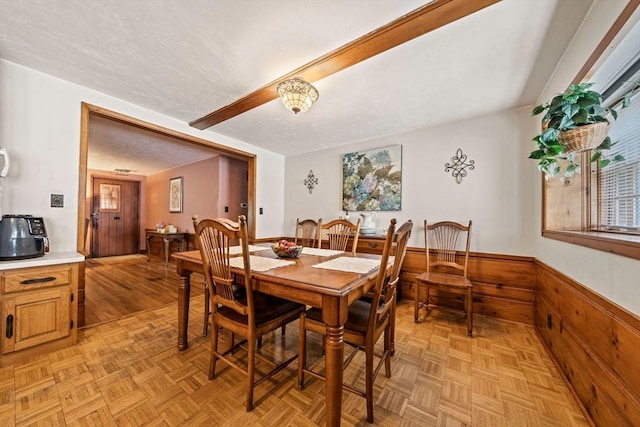 70 Bestick Rd, Braintree, MA 02184 - dining space with wainscoting, wooden walls, and beamed ceiling